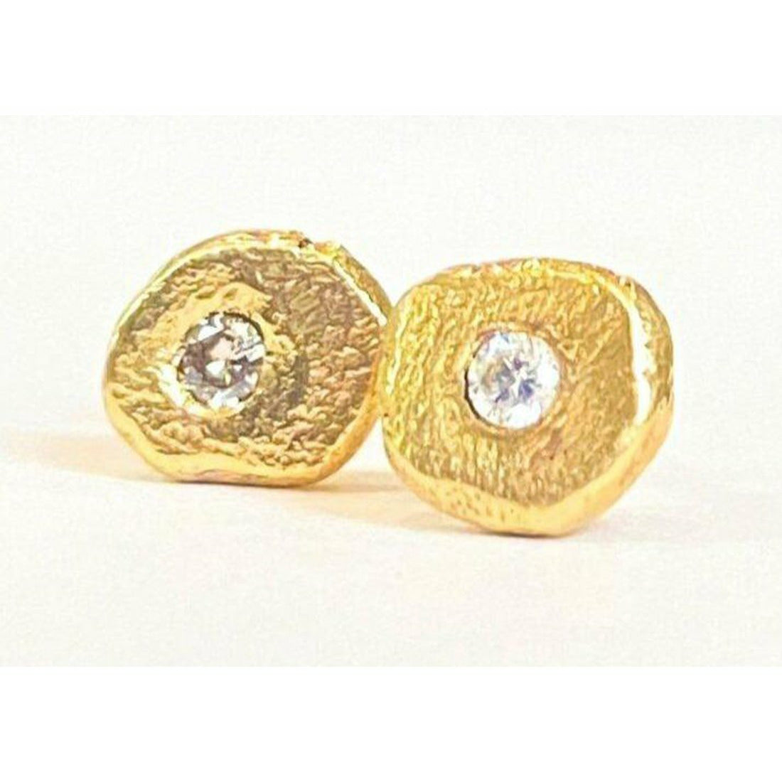 Add a touch of elegance and sophistication to your look with these stunning textured diamond stud earrings. The intricate textured design adds a unique twist to the classic diamond studs, creating a sparkling and glamorous accessory that will elevate any outfit. 1.8 mm pointer diamond flush set. 6mm-6.25 not a regular shape textured. small butterfly back.