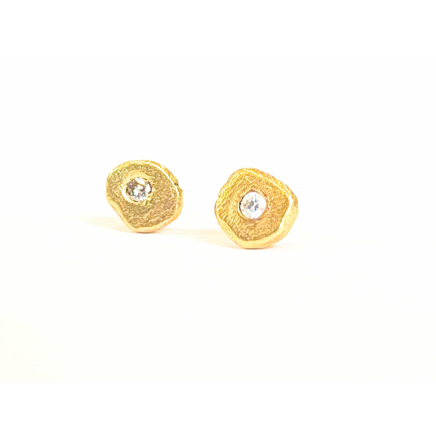 Add a touch of elegance and sophistication to your look with these stunning textured diamond stud earrings. The intricate textured design adds a unique twist to the classic diamond studs, creating a sparkling and glamorous accessory that will elevate any outfit. 1.8 mm pointer diamond flush set. 6mm-6.25 not a regular shape textured. small butterfly back.