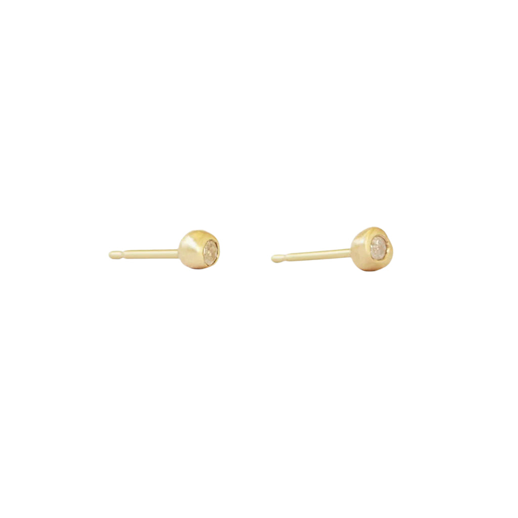Add a touch of elegance to your everyday look with these stunning Dainty Ball Diamond Stud Earrings. Classic ball studs, with a Diamond they are  comfortable and Essential. Great for 2nd and 3rd ear piercings and cartilage earrings.   Details  2 x 1.5mm diamond 14k Yellow Gold W x T 3.5mm x 3.5mm