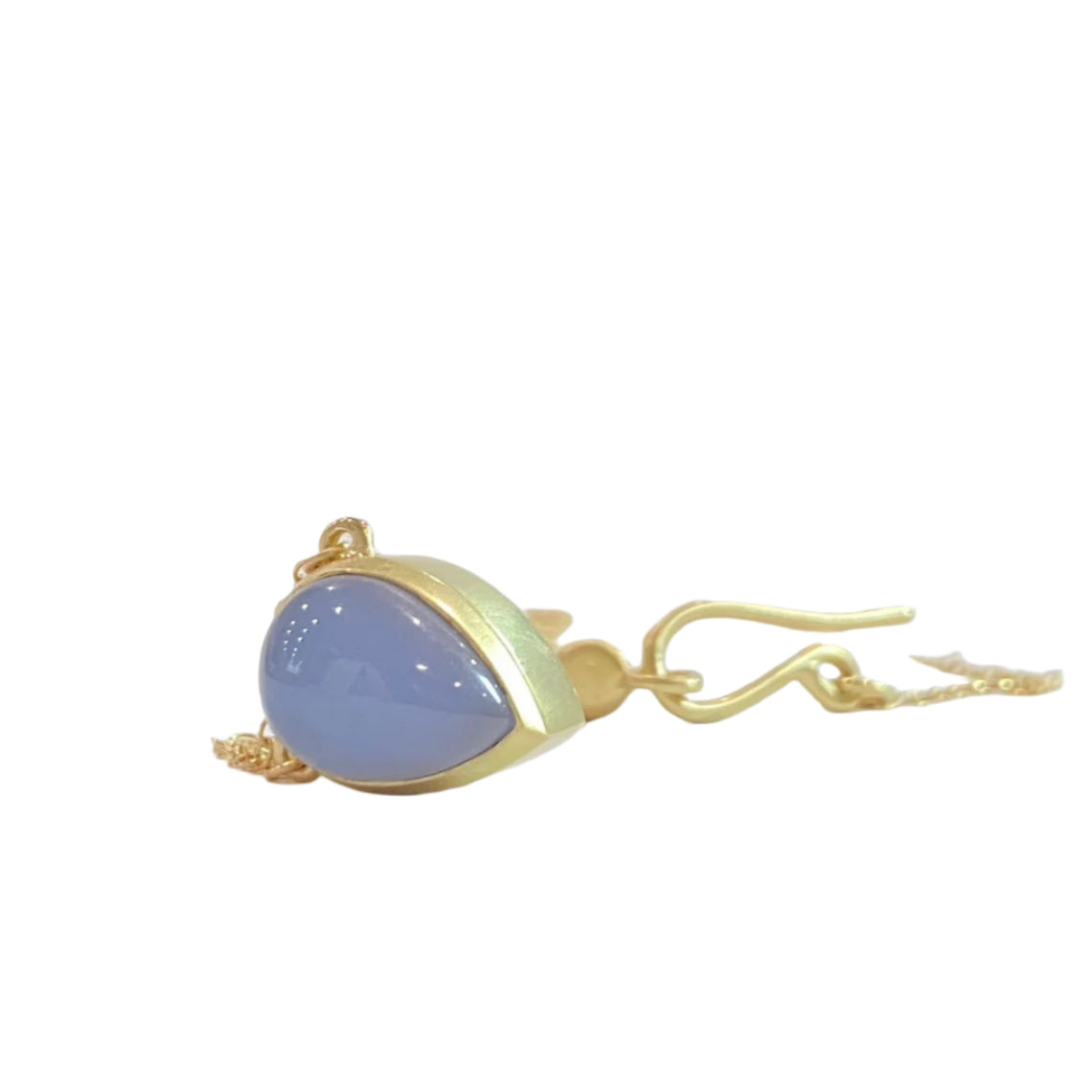 Keep your loved ones close to your heart with our cremation illumination Necklace . Crafted with care, this necklace allows you to carry a small portion of their ashes, providing comfort and a constant reminder of their presence.. Pendant 15mm long x 10 mm wide Handmade clasp Chain with Clasp 16 inch long. 14k Yellow Gold Stone Chalcedony