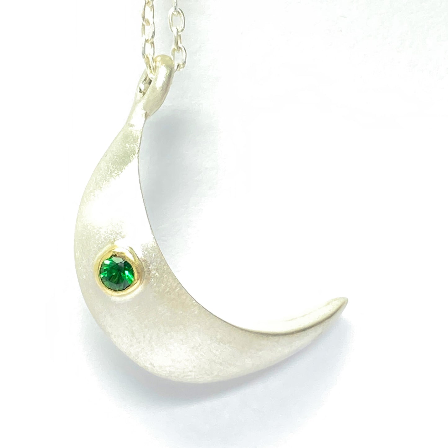 Keep your loved ones close to your heart with our cremation moon necklace. Crafted with care, this necklace allows you to carry a small portion of their ashes, providing comfort and a constant reminder of their presence. Details. -1 inch Handmade moon from the top of moon to the bottom. -The ashes are securely inside the hollow moon. - Stone of your choice. - 24 inch cable chain. - Satin finish or high polish - choice of stone, depending on the stone price may vary.