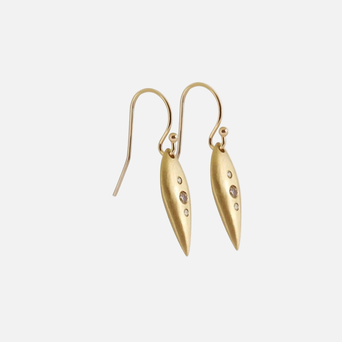 Details Introducing our exquisite POD EARRINGS, adorned with three dazzling diamonds. These earrings are the perfect accessory to add a touch of sparkle and sophistication to any outfit. Treat yourself or someone special to these stunning earrings today! 4 x 1.5mm Round White Diamonds 2 x 2.25mm Round White Diamonds 14k Yellow Gold Satin Finish HxW: 27.6mm x 6.1mm