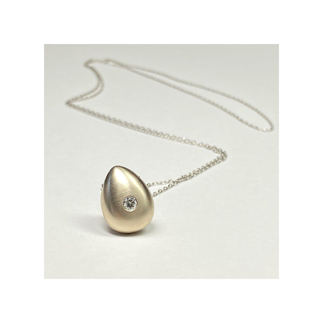 Keep your loved ones close to your heart with our cremation Diamond necklace. Crafted with care, this necklace allows you to carry a small portion of their ashes, providing comfort and a constant reminder of their presence.Holding Diamond Cremation ashes memorial Urn Pendant     Details  -3mm 10 pointer Diamond  -1.5 mm 24 inch cable chain is endless with no catch, you can also specify the length there may be a extra charge.