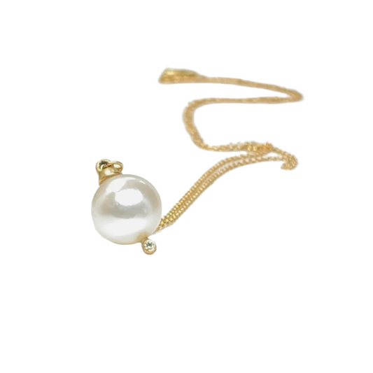 A classic single Japanese pearl necklace with a diamond to give it that extra sparkle.  Details  8mm Japanese Pearl 1 Round White Diamond 0.05ct Pendant measures 16.5mm x 9.75mm 18" Chain 14k Yellow Gold Satin Finish