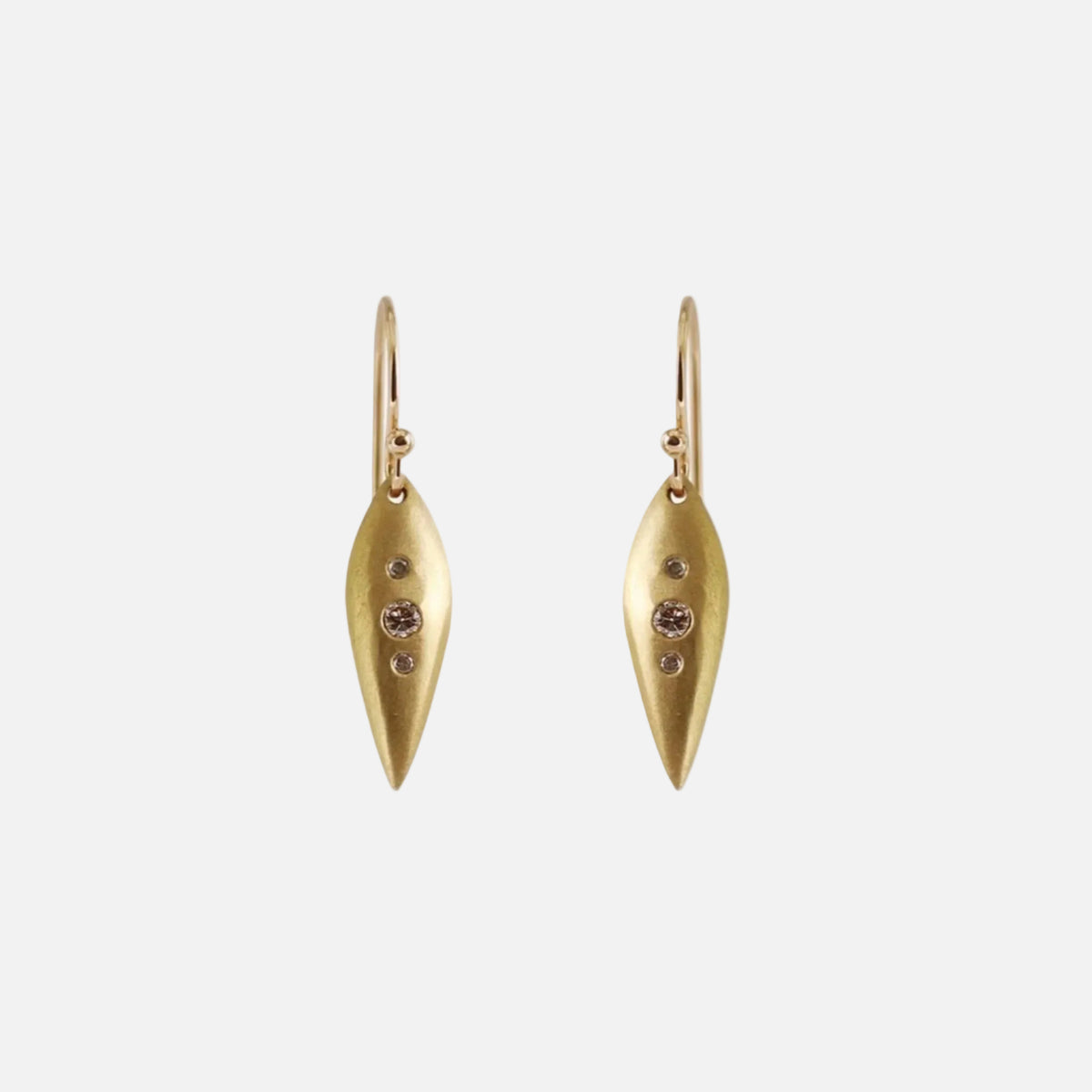 Details  Introducing our exquisite POD EARRINGS, adorned with three dazzling diamonds. These earrings are the perfect accessory to add a touch of sparkle and sophistication to any outfit. Treat yourself or someone special to these stunning earrings today!  4 x 1.5mm Round White Diamonds 2 x 2.25mm Round White Diamonds 14k Yellow Gold Satin Finish HxW: 27.6mm x 6.1mm  