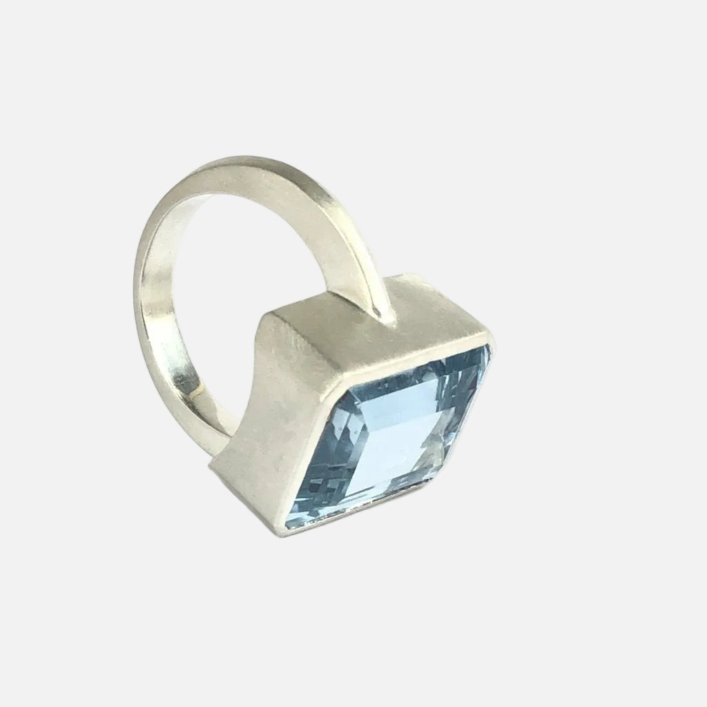 Add a touch of elegance to any outfit with this stunning Bright Blue Topaz Cocktail Ring. The vibrant blue color of the topaz stone is sure to catch everyone's eye, and the elegant cocktail design adds a sophisticated touch. Treat yourself or someone special to this eye-catching ring today!  16mm x 12mm Blue Topaz.