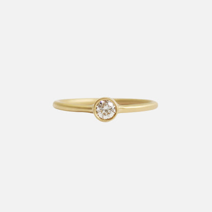 Details  Indulge in the timeless elegance of our Single Diamond Ring. This sparkling centerpiece features exquisite craftsmanship that will captivate your heart and dazzle on your finger. Elevate your style and make a statement with this stunning piece of jewelry.  3mm Round White Diamond Round Band 14k Yellow Gold Satin Finish WxT: 1.45mm
